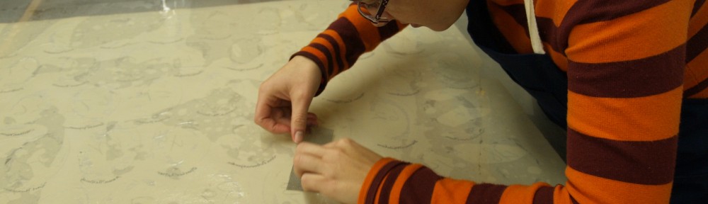 Image showing Lisa Duncan performing conservation treatment on the paper support of a photo assemblage.